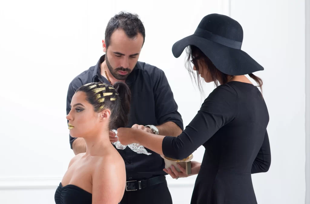 Two J. Joseph Salon stylists finishing an editorial updo
